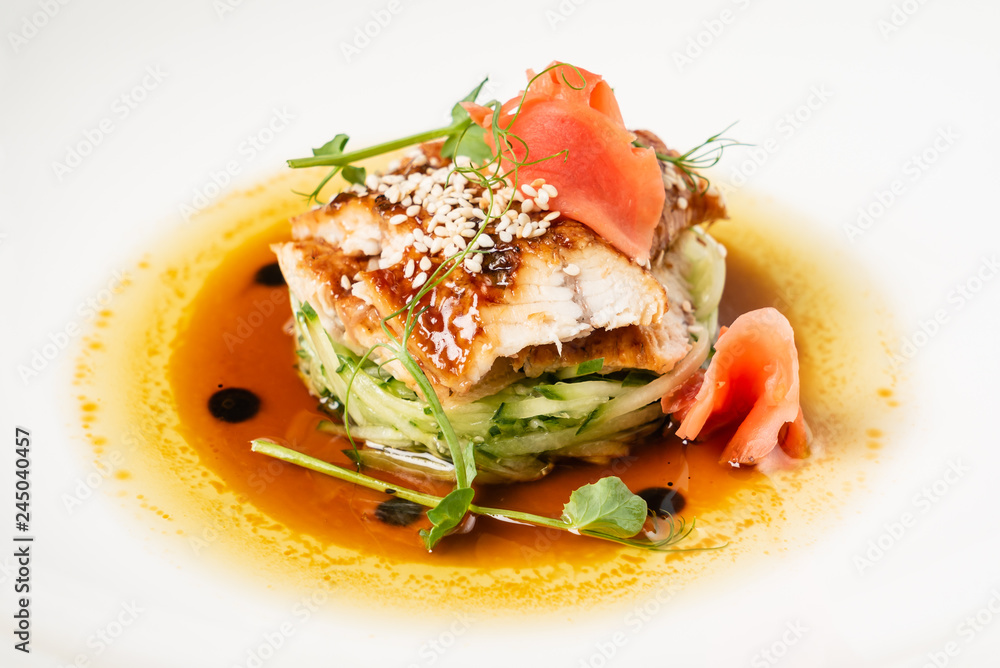 Fried eel with vegetables on the white plate Fried eel with vegetables on the white plate
