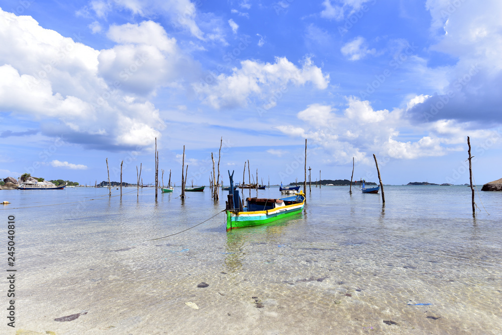 Small fishing boats at the beach of Tanjung Kelayang in Belitung Island, Indonesia Small fishing boats at the beach of Tanjung Kelayang in Belitung Island, Indonesia