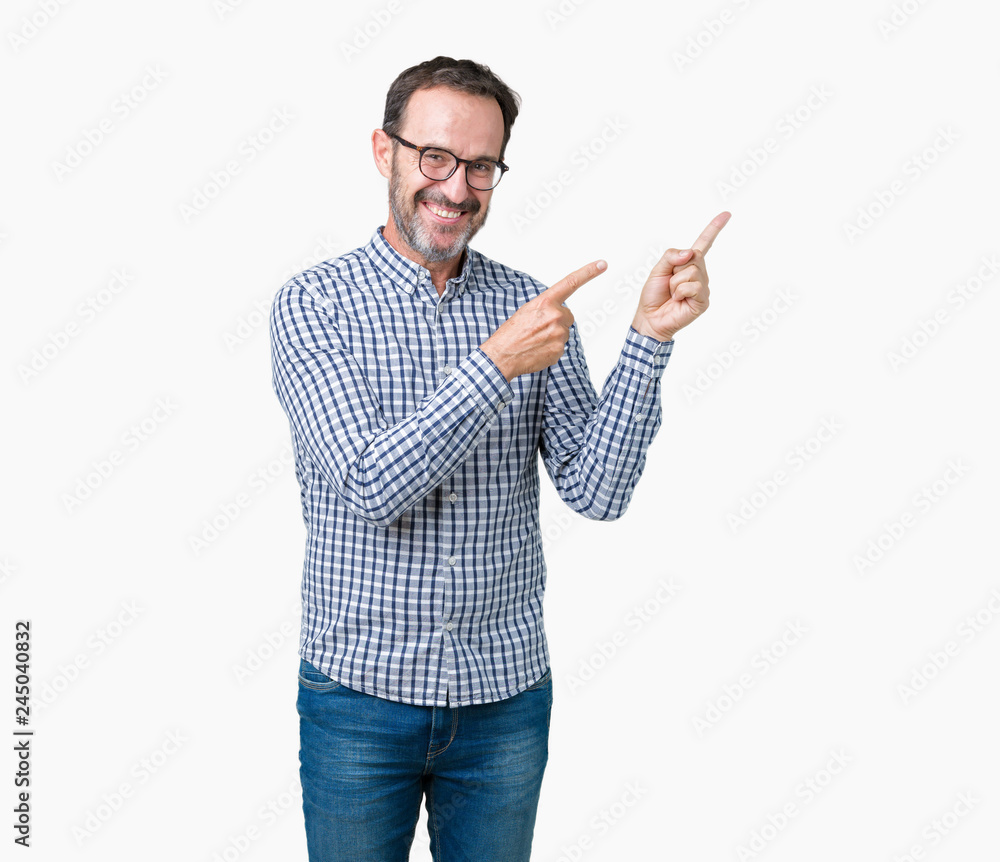 Handsome middle age elegant senior business man wearing glasses over isolated background smiling and looking at the camera pointing with two hands and fingers to the side. Handsome middle age elegant senior business man wearing glasses over isolated background smiling and looking at the camera pointing with two hands and fingers to the side.