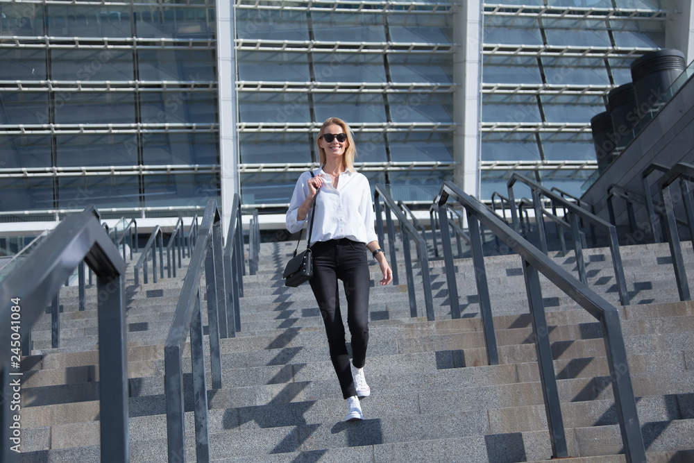 business woman in sunglasses walking on the street business woman in sunglasses walking on the street