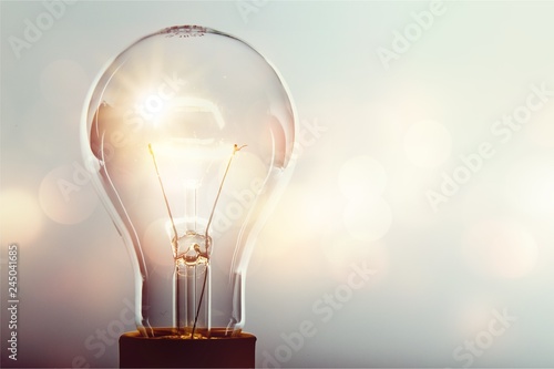 Stampa su tela Glowing yellow light bulb, busienss idea concept