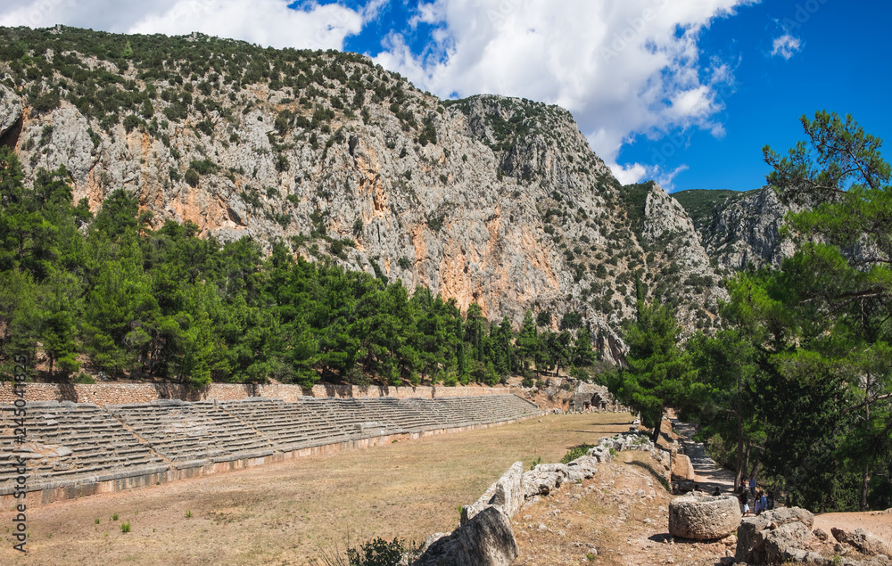 Tourists visit to the Stadium of Delphi in the highest spot of the Archaeological Site of Delphi, Central Greece Tourists visit to the Stadium of Delphi in the highest spot of the Archaeological Site of Delphi, Central Greece