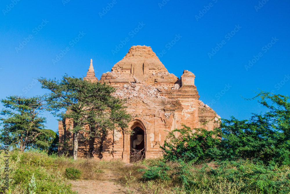 Dilapidated temple with a Buddha statue inside in bagan, Myanmar