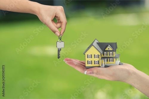 Hand giving set of house keys