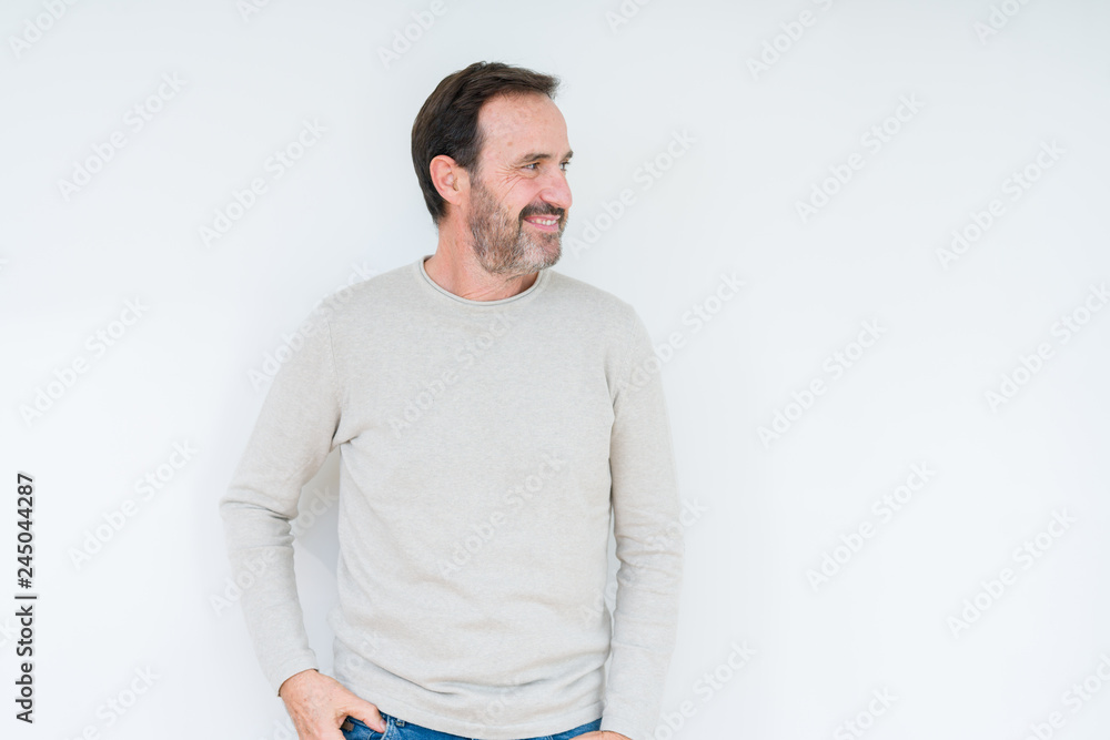 Elegant senior man over isolated background looking away to side with smile on face, natural expression. Laughing confident. Elegant senior man over isolated background looking away to side with smile on face, natural expression. Laughing confident.