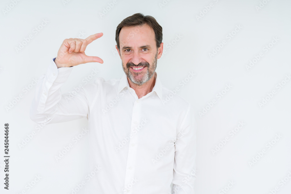 Elegant senior man over isolated background smiling and confident gesturing with hand doing size sign with fingers while looking and the camera. Measure concept. Elegant senior man over isolated background smiling and confident gesturing with hand doing size sign with fingers while looking and the camera. Measure concept.