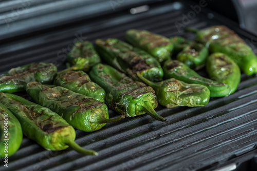 Grilled green bell peppers on electric grill spanish style. Close up