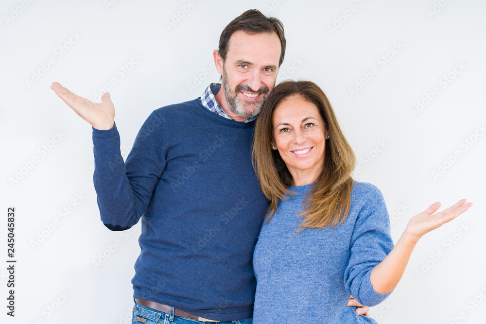 Beautiful middle age couple in love over isolated background Smiling showing both hands open palms, presenting and advertising comparison and balance Beautiful middle age couple in love over isolated background Smiling showing both hands open palms, presenting and advertising comparison and balance