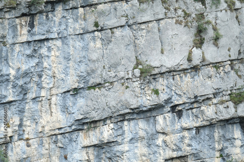Close up Dolomite rock textures and layer in different colours. Grey, dark grey, white, and iron brown. Trentino, Northern Italy Europe.