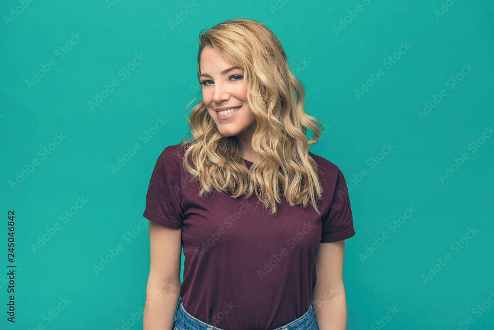 Portrait of smiling woman on blue background. Portrait of smiling woman on blue background.