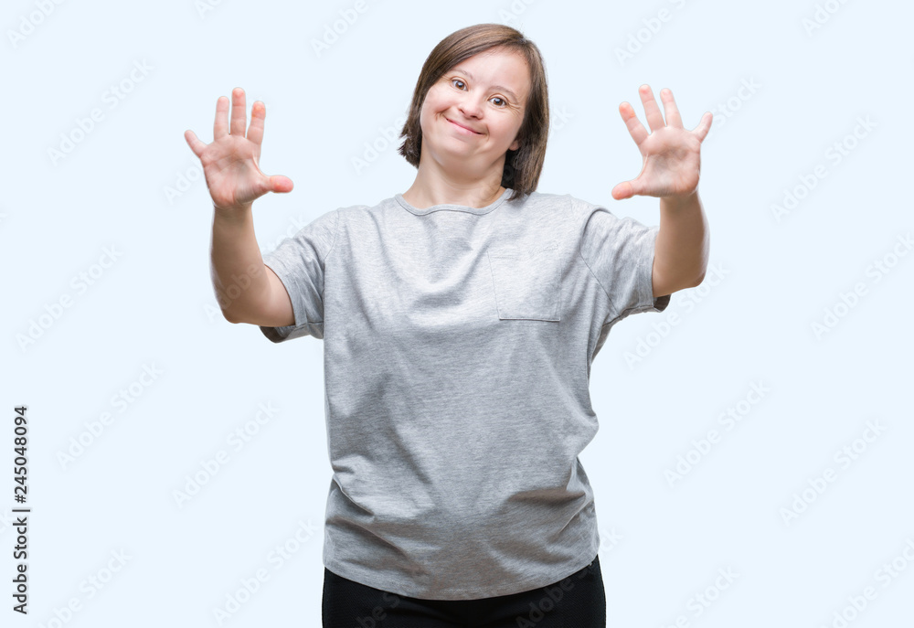 Young adult woman with down syndrome over isolated background showing and pointing up with fingers number ten while smiling confident and happy. Young adult woman with down syndrome over isolated background showing and pointing up with fingers number ten while smiling confident and happy.