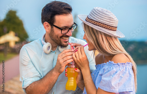 Dating. Loving couple drinking juice together. Love and romance