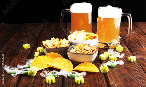 st patricks day with Chips, salty snacks, and Beer on a table. Saint celebration with lucky shamrock