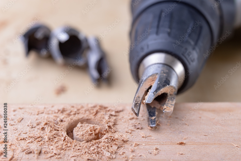 Drilling holes in the carpentry workshop with a special drill. Joinery accessories for repair work. Drilling holes in the carpentry workshop with a special drill. Joinery accessories for repair work.
