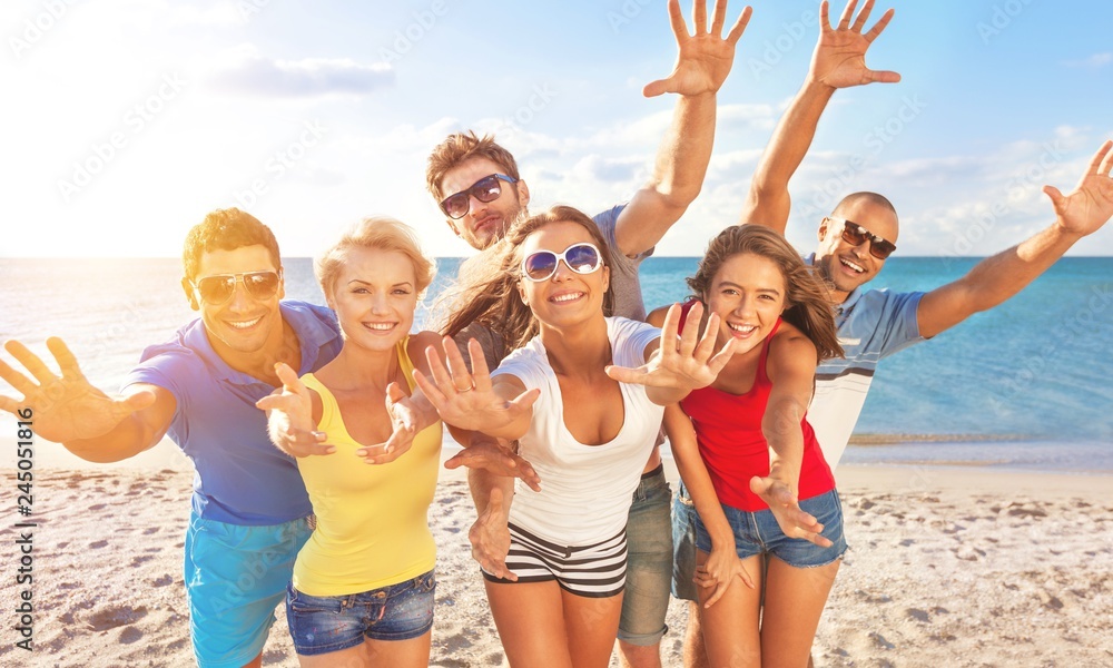 Group of happy friends having fun together on the beach Group of happy friends having fun together on the beach