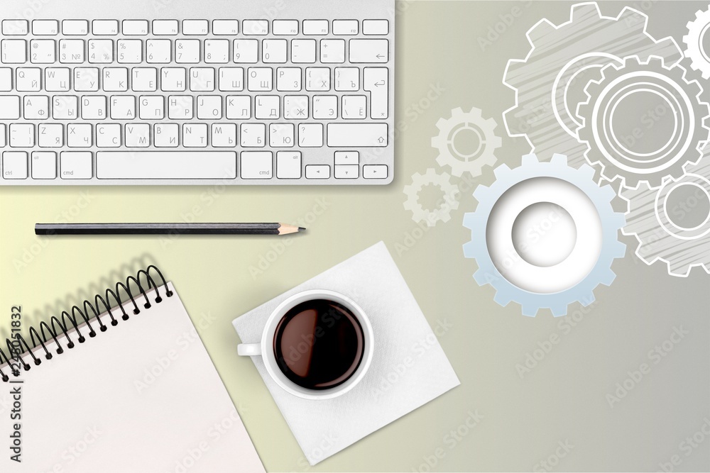 Computer keyboard at workplace and cup isolated on  background