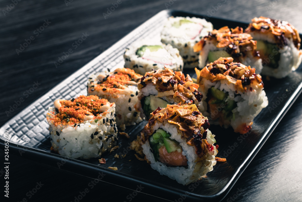 close up of sushi rolls on black tray close up of sushi rolls on black tray