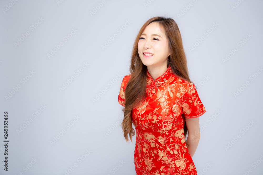 Beautiful portrait happy Chinese New Year young asian woman wear cheongsam smile with gesture congratulation and greeting isolated on white background, festival and celebrate concept. Beautiful portrait happy Chinese New Year young asian woman wear cheongsam smile with gesture congratulation and greeting isolated on white background, festival and celebrate concept.