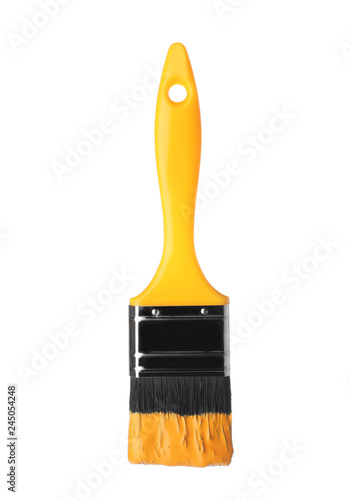 Brush with yellow paint on white background