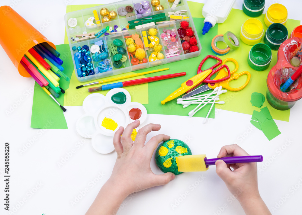 The child makes a craft toy from foam plastic tortoise. Material for creativity and education. The child makes a craft toy from foam plastic tortoise. Material for creativity and education.