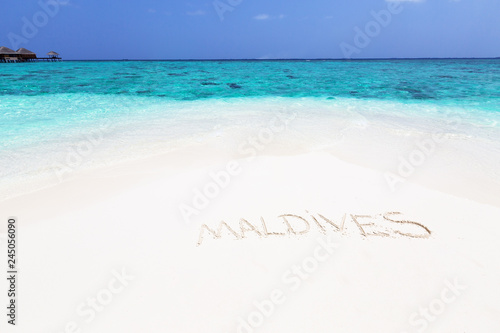 Handwriting word on maldivian beach