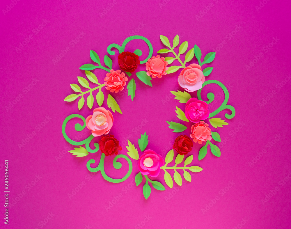 Flower made of paper pink background. Trend color pastel coral. Wreath in a circle