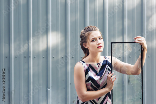 Beautiful teen girl holding broken glass in her hands. concept to overcome challenges in adolescence.