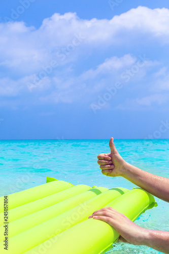 Swimming color green mattress on turquoise sea