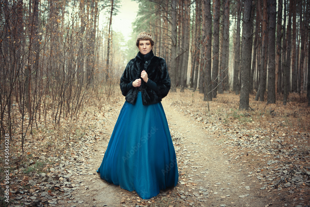 Fototapeta premium Model wearing blue skirt is posing as a queen