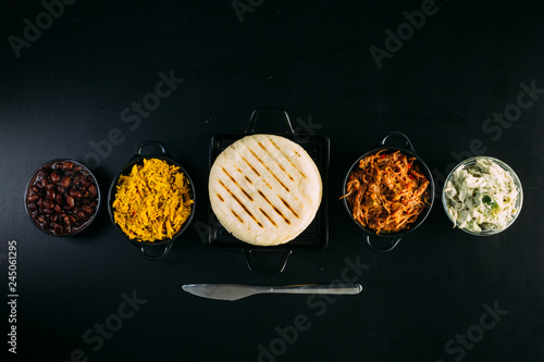 Top view of South American food called arepa and different ingredients