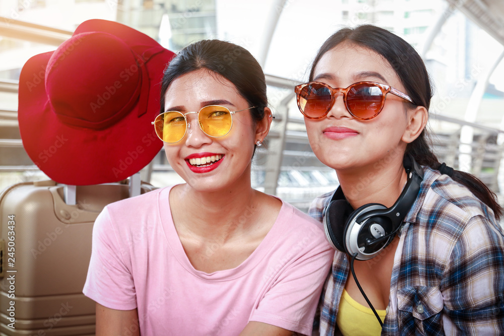2 Asian tourists, wearing glasses and headphones 2 Asian tourists, wearing glasses and headphones