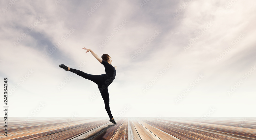 Fototapeta premium Gymnast girl in jump Mixed media