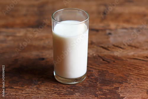 glass of fresh  milk on wooden table background 