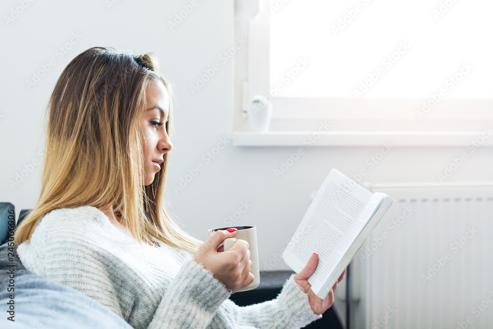 Beautiful girl drinking coffee, and reading book. Beautiful girl drinking coffee, and reading book.