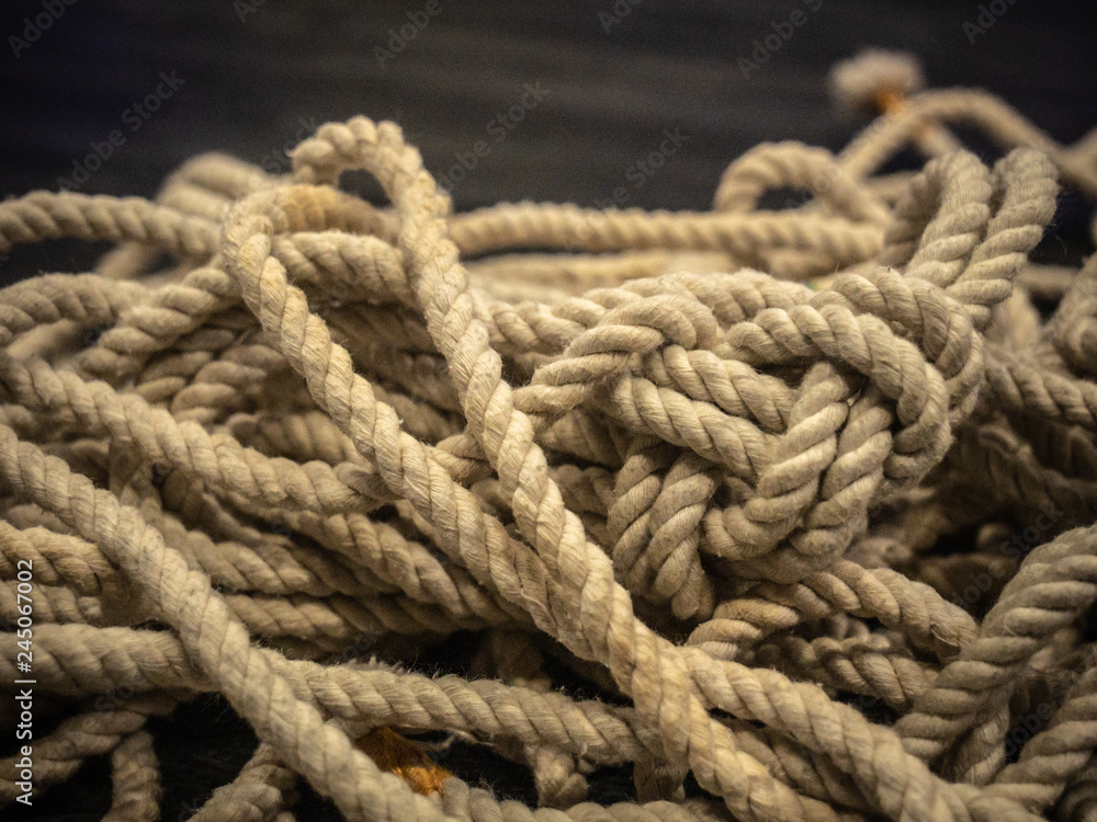 Pile of worn cotton rope with whipped ends