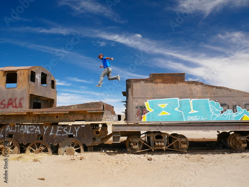 Obraz na płótnie Jumping the train. Train cemetary near Uyuni, Bolovia w salonie
