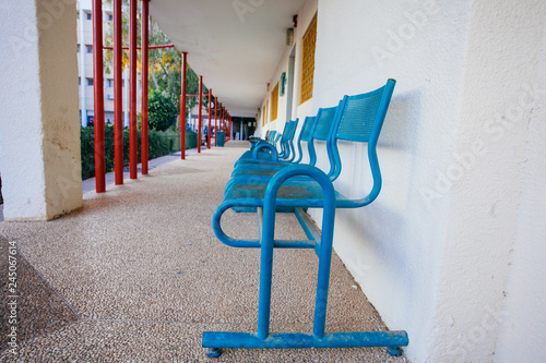 Blue bench in school yard photo