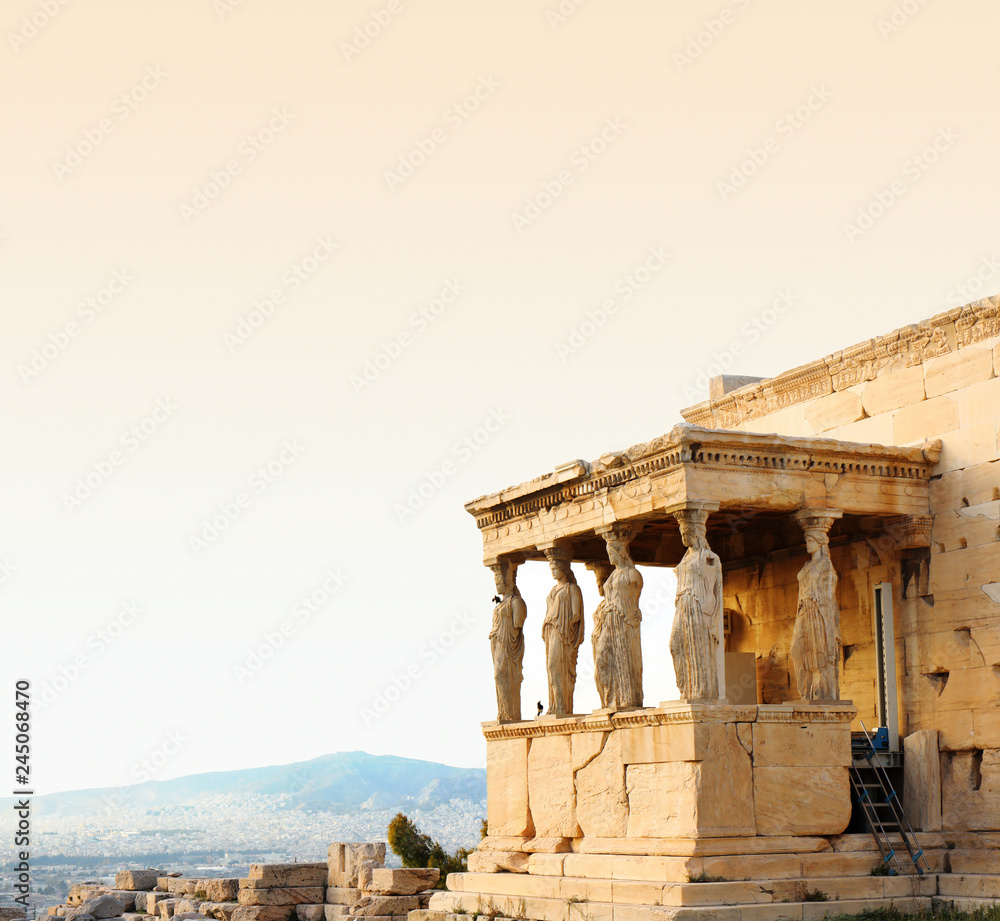Fototapeta premium Acropolis, Erectheion, caryatids with panoramic view of the Athens, Greece