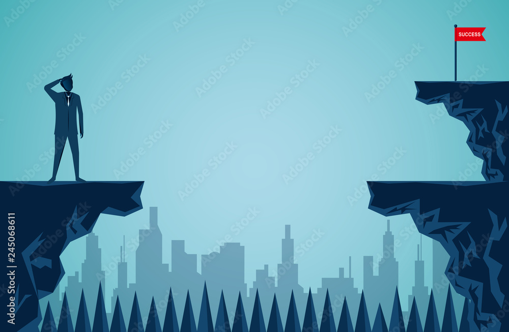 businessman stand on a cliff looking at the red flag at the opposite ...