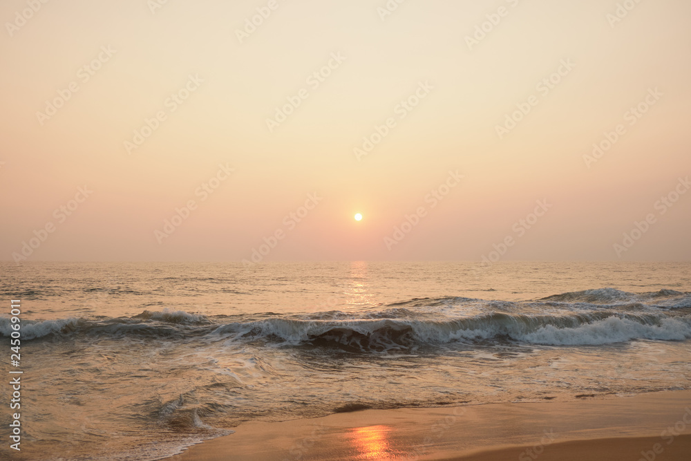 Stunning sunset on the beach overlooking the ocean and the waves. Stunning sunset on the beach overlooking the ocean and the waves.