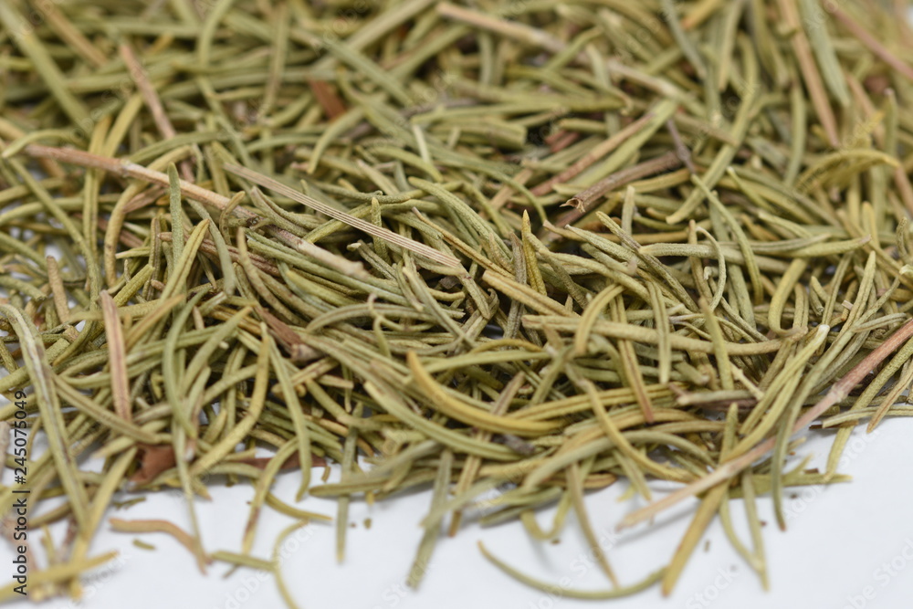 dried rosemary in a porcelain plate - close up of a rosemary background food dried rosemary in a porcelain plate - close up of a rosemary background food