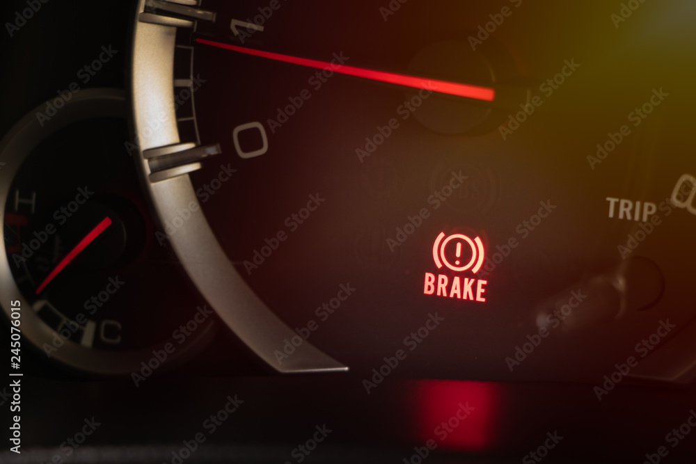 Naklejka premium warning light handbrake in car dashboard