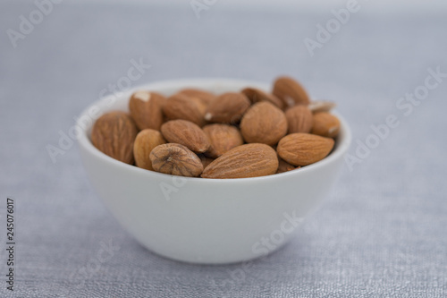 Dried almons in porcelain bowl photo