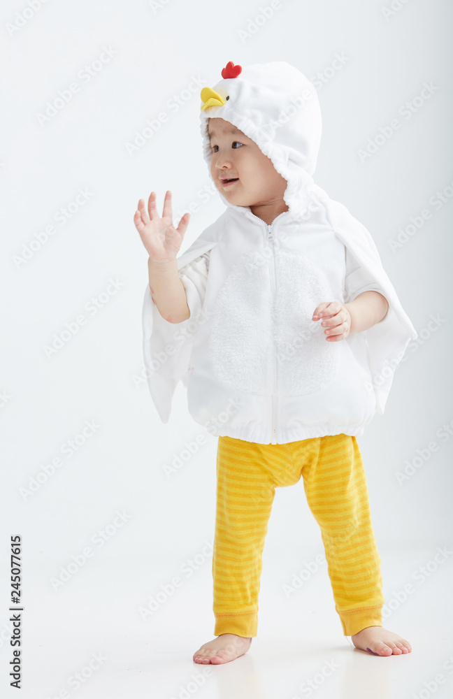 Cute Asian little girl wearing a chicken costume. On white background Cute Asian little girl wearing a chicken costume. On white background