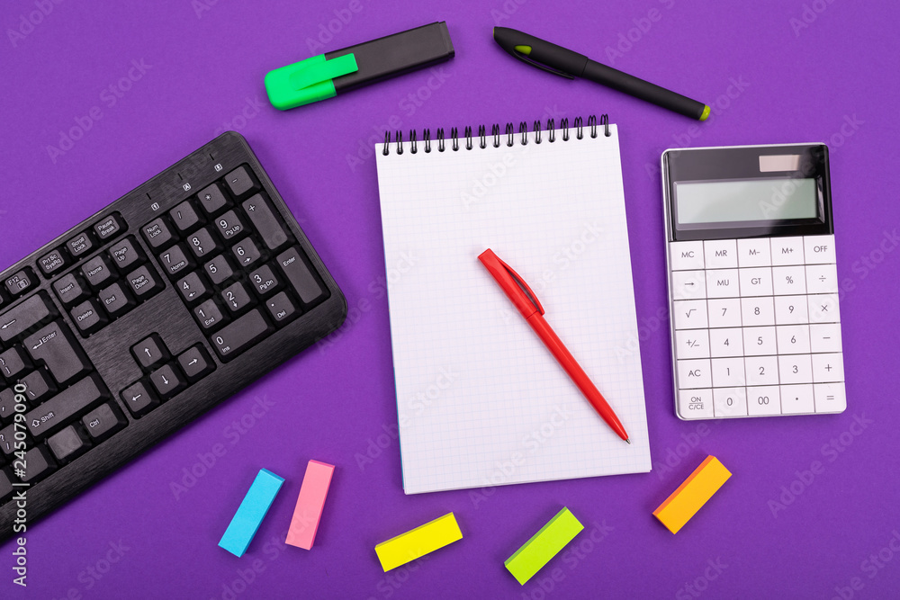 Modern workspace with calculator, notebook and pen on color background. Top view. Flat lay style Modern workspace with calculator, notebook and pen on color background. Top view. Flat lay style