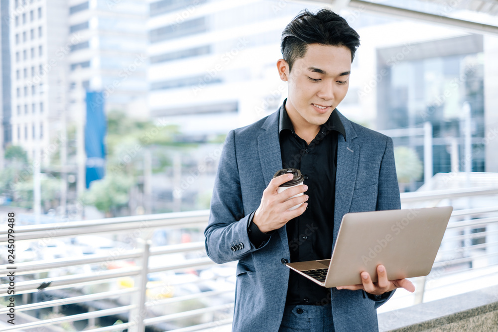 Young business man use notebook laptop for internet social network work project in city. Young business man use notebook laptop for internet social network work project in city.