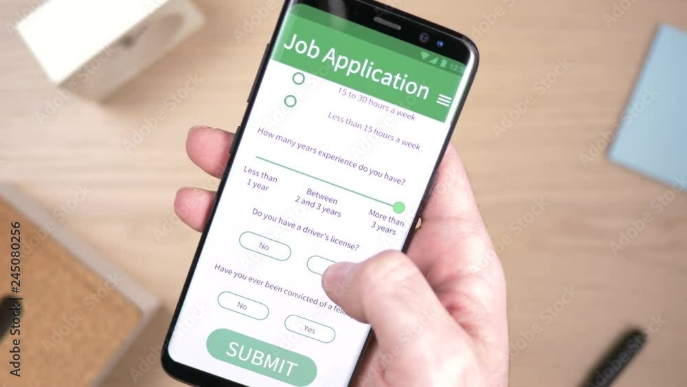 Filling a job application form online on a smartphone screen. Filling a job application form online on a smartphone screen.