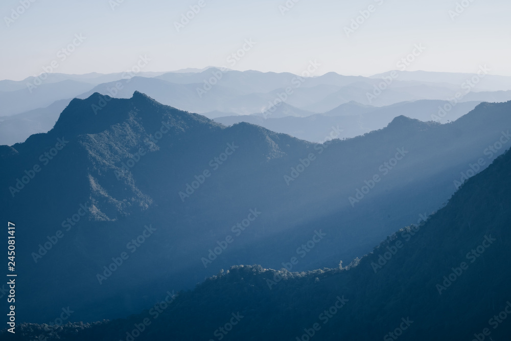 Fototapeta premium Mountain layer with sun ray scenic landscape morning in bright sky.