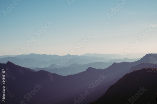 Mountain layer with sun ray scenic landscape morning in bright sky. © sirins