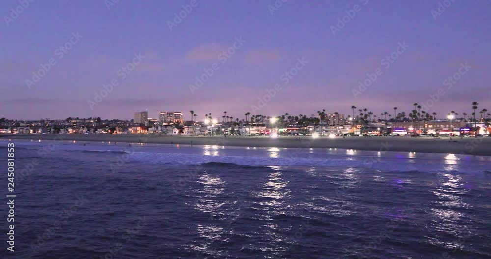 View of the city of Newport Beach and the Pier during the sunset time. View of the city of Newport Beach and the Pier during the sunset time.